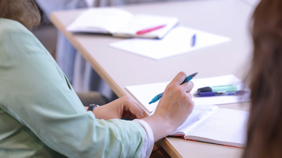 A participant is taking notes