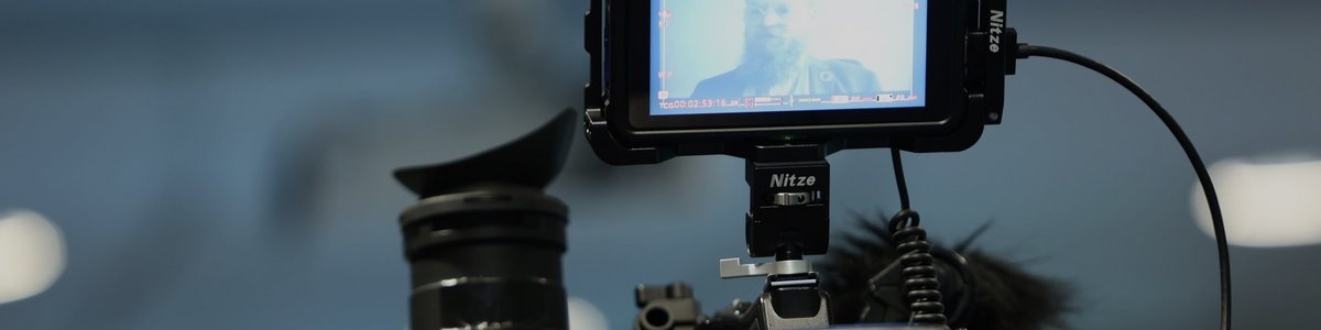 A man is being filmed by a camera. 