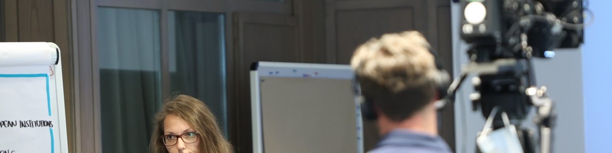 A television crew is filming the presenter of an event.