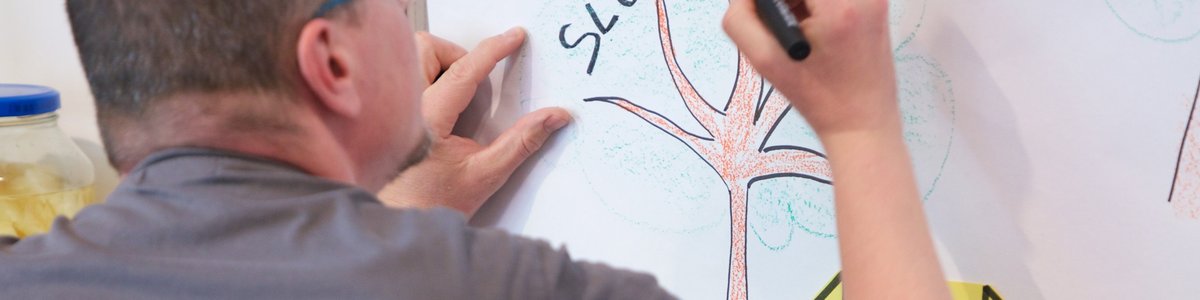 A man writes Slovenia on a poster