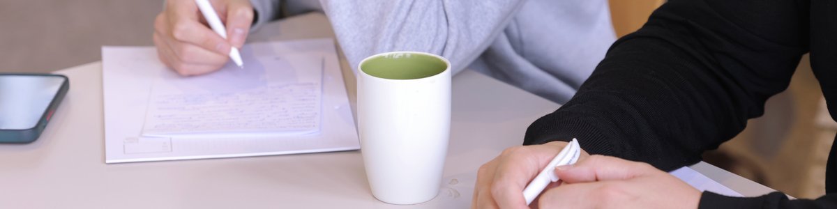 Two participants are taking notes.