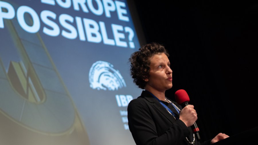 A woman moderates at an event.